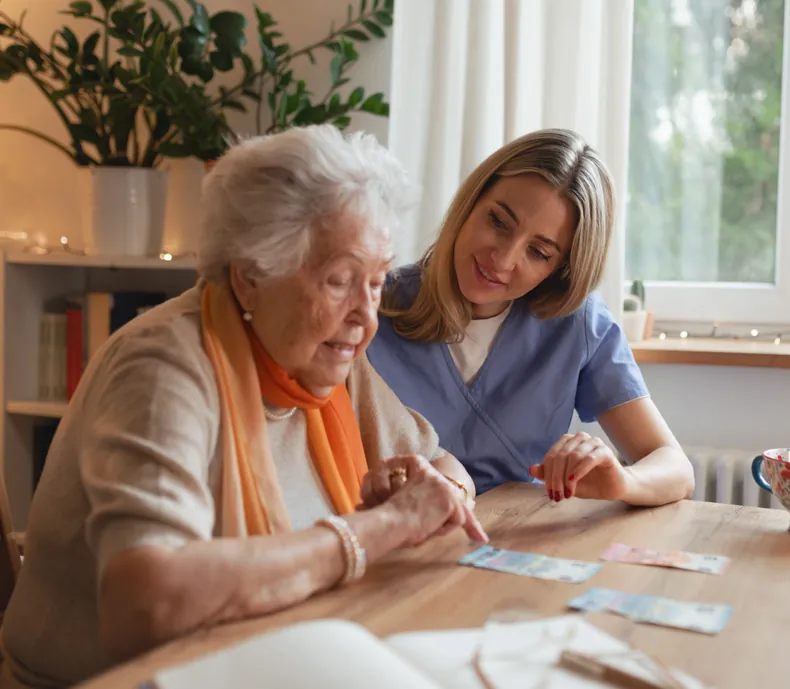 Nurse helping a senior with medication at home in Dubai