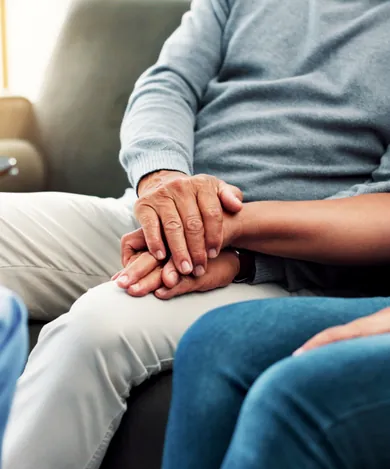 Private nurse at home in Dubai holding a patient’s hand